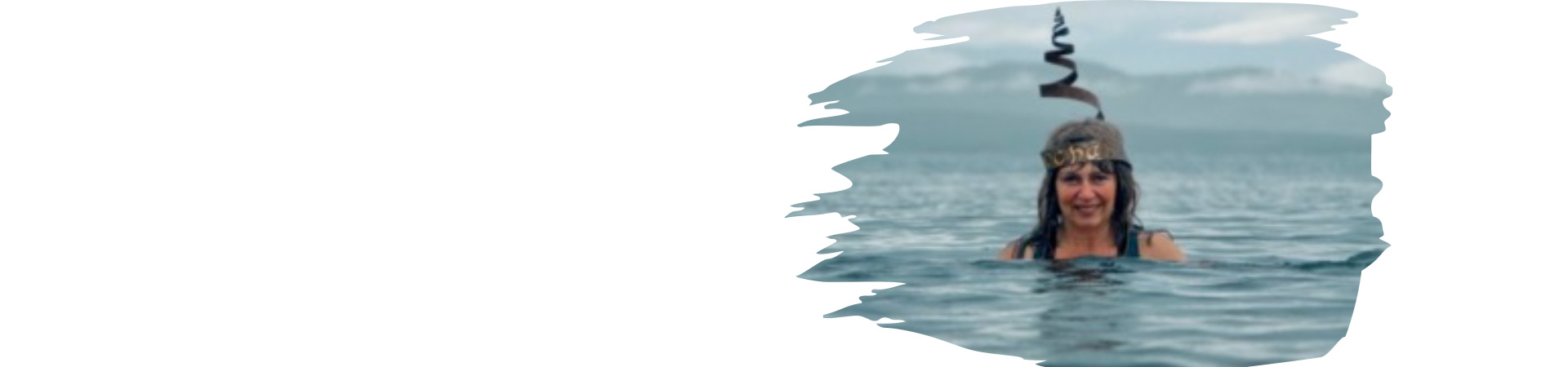 SAMS scientist swimming underwater wearing a headdress embossed with Antarctic microalgae images