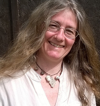 Mandy Haggith wearing glasses and a white blouse