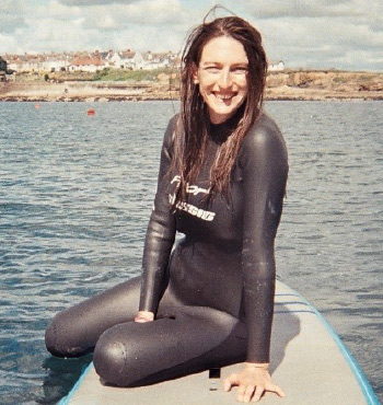 A photo of trustee Helen Mitcheson smiling into the camera wearing a wetsuit