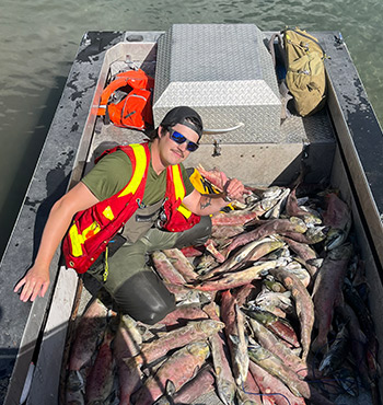 Kevan on a boat with fish