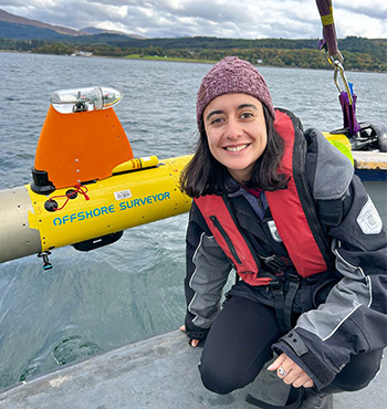 Alejandra Mejía-Saenz next to an AUV