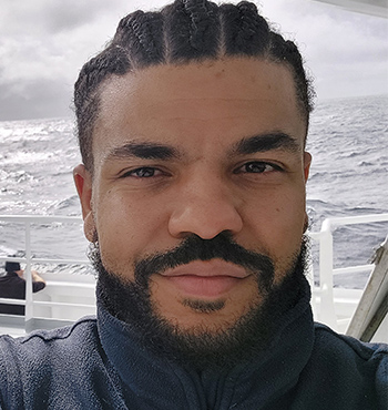 Dr Sam Tiéfolo Diabaté on a research vessel, head and shoulder shot.
