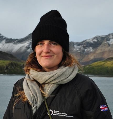 Head and shoulders photo of biogeochemist Lisa Friberg in dark woolly hat in a wintery coastal area