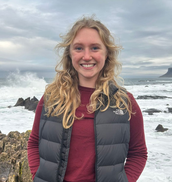 Jenny black pictured on a dramatic coastal landscape.