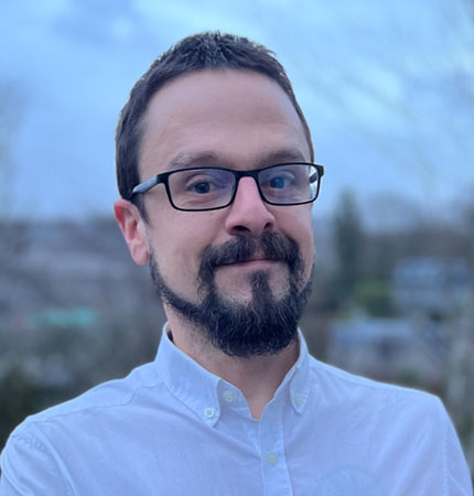 Business Development Manager Daniel Carcajona pictured on a dramatic coastal landscape.