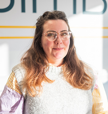 Head and shoulder picture of Sine MacKay in a workshop where SIMBA instruments are made