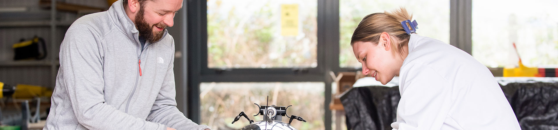 marine scientists looking at a marine robot