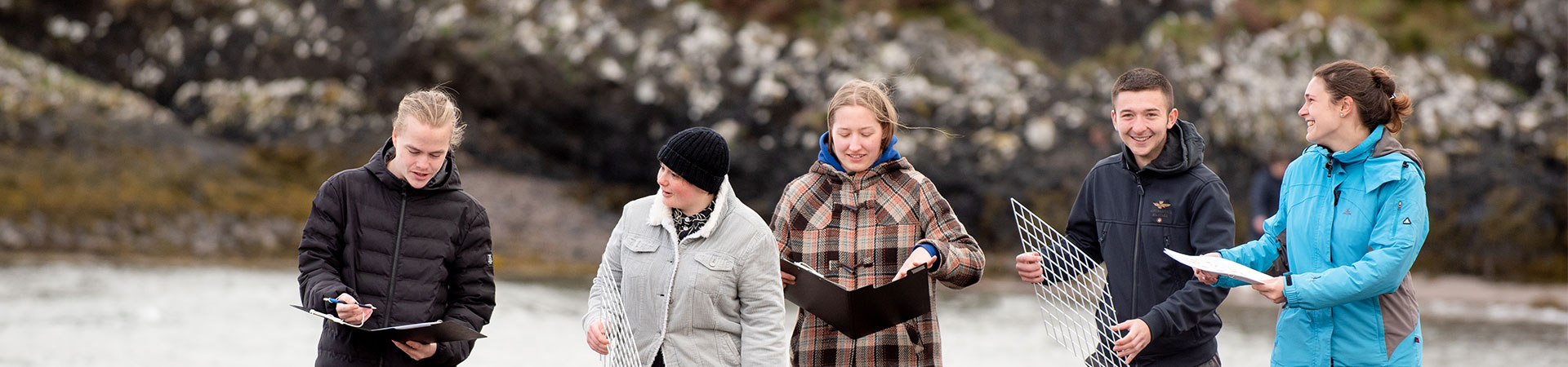 students walking at the beach
