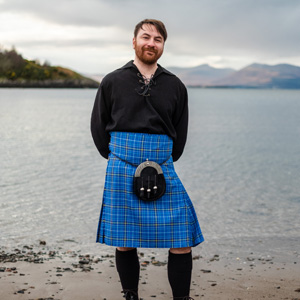 SAMS scientist wearing the Ocean tartan kilt on the seashore